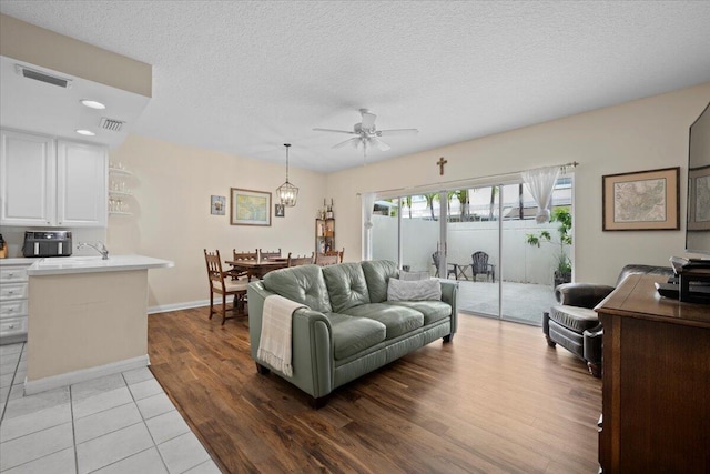 11 Live Oak Cir Unit 11, Tequesta, FL 33469 - living area featuring ceiling fan, light wood-style floors, a textured ceiling, and recessed lighting