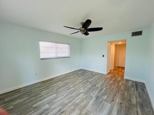 1120 99th St Unit 301, Bay Harbor Islands, FL 33154 - unfurnished room with wood finished floors and ceiling fan