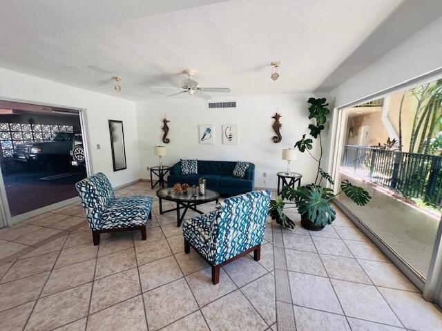 1120 99th St Unit 301, Bay Harbor Islands, FL 33154 - living room featuring light tile patterned floors and ceiling fan