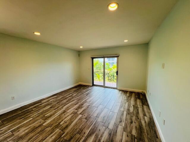 1120 99th St Unit 301, Bay Harbor Islands, FL 33154 - empty room featuring dark wood-type flooring and recessed lighting