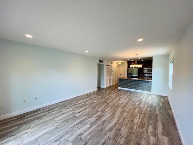 1120 99th St Unit 301, Bay Harbor Islands, FL 33154 - unfurnished living room featuring wood finished floors, a chandelier, and recessed lighting