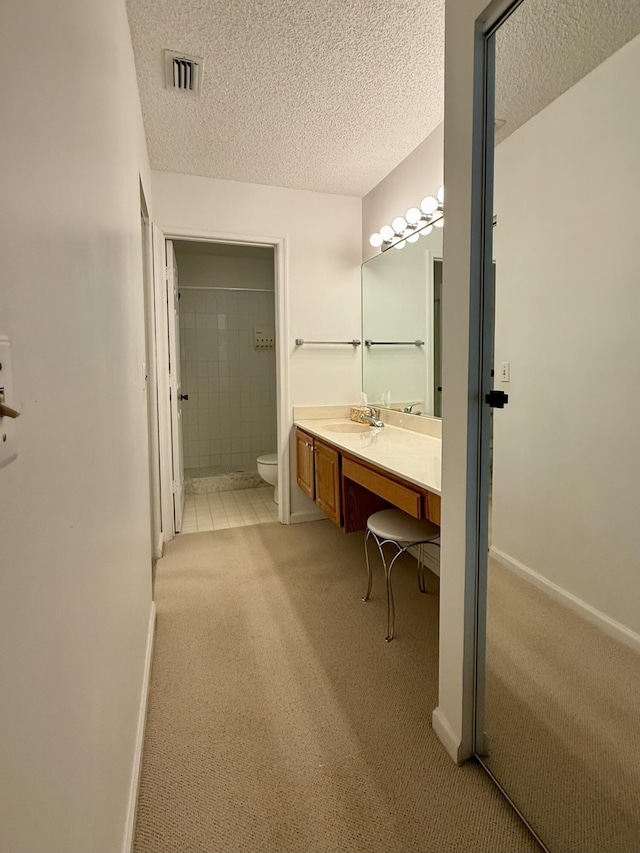 1142 Keystone Dr Unit C, Jupiter, FL 33458 - bathroom with a tile shower, vanity, and a textured ceiling
