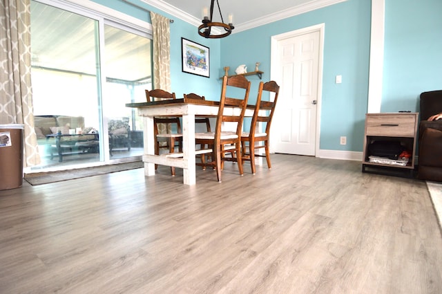 5447 SE 51st Dr, Stuart, FL 34997 - dining room with ornamental molding, a chandelier, and wood finished floors