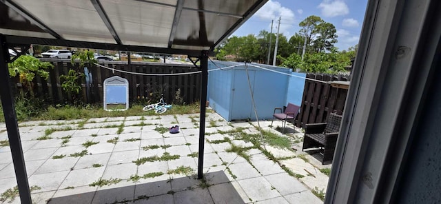 4732 Chariot Cir, Greenacres, FL 33463 - fenced backyard featuring a patio area and a storage unit