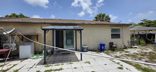 4732 Chariot Cir, Greenacres, FL 33463 - rear view of property with washer / clothes dryer, stucco siding, a patio, and a gazebo