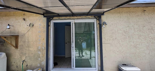 4732 Chariot Cir, Greenacres, FL 33463 - property entrance with stucco siding and washer / clothes dryer