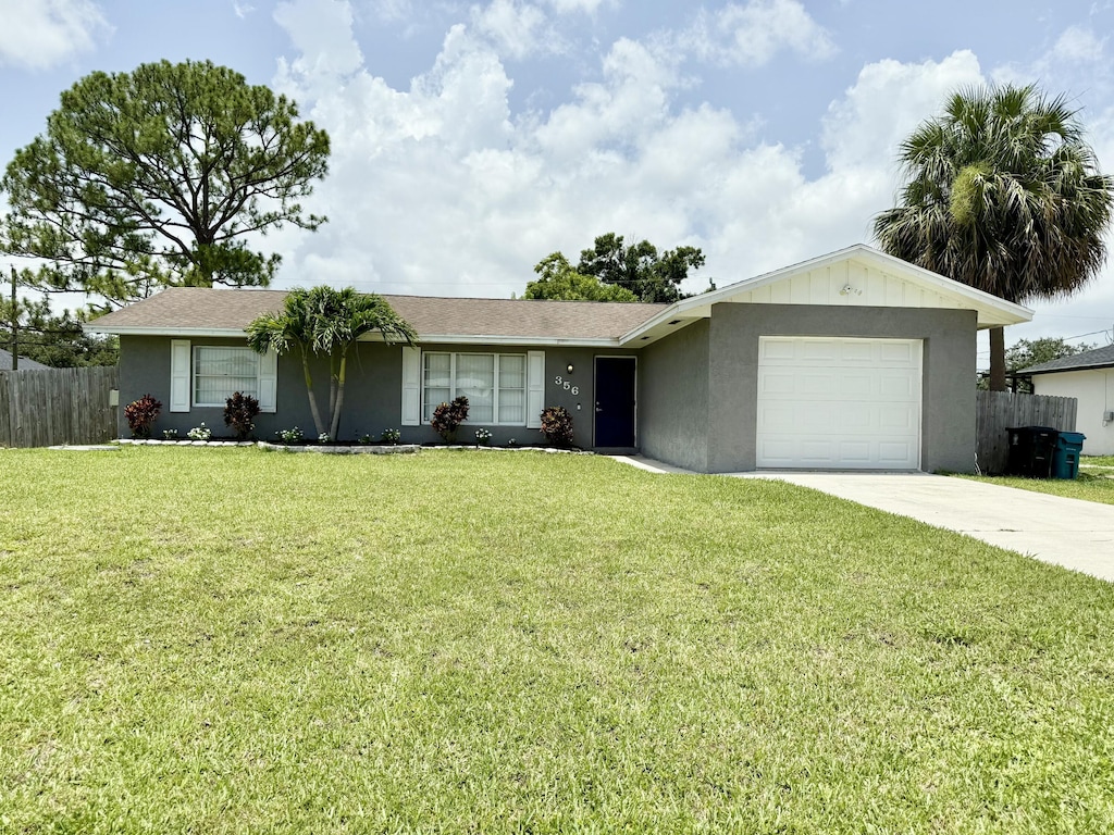 356 NW Hibiscus St, Port Saint Lucie, FL 34983 - single story home featuring a garage, concrete driveway, and stucco siding