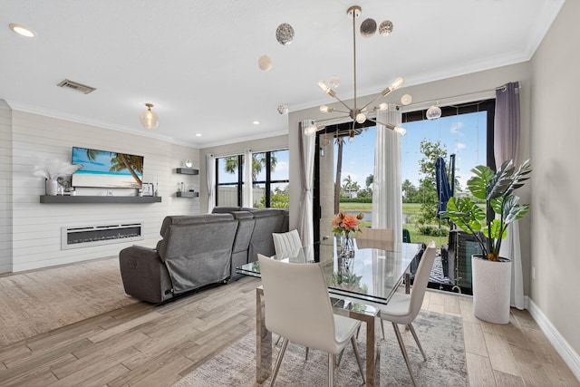 8343 Cinch Way, Lake Worth, FL 33467 - dining space featuring crown molding, wood finished floors, a chandelier, recessed lighting, and a glass covered fireplace