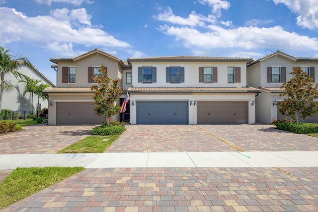 8343 Cinch Way, Lake Worth, FL 33467 - view of front of property with an attached garage, decorative driveway, stucco siding, and a tiled roof
