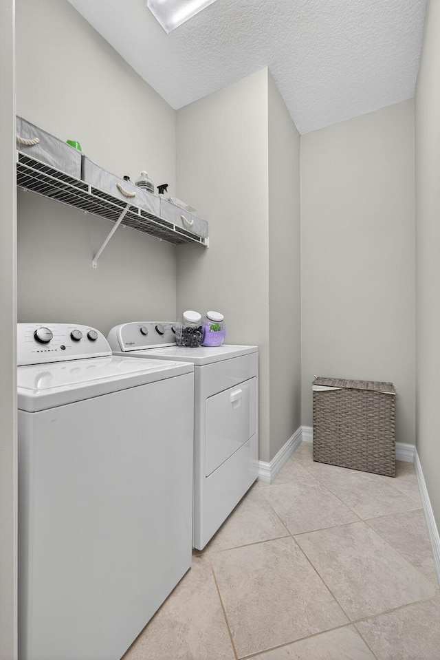 8343 Cinch Way, Lake Worth, FL 33467 - laundry room with separate washer and dryer, light tile patterned floors, and a textured ceiling