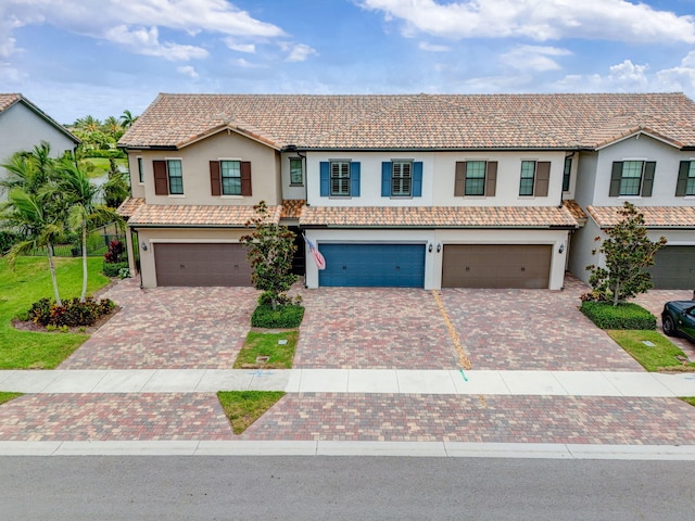 8343 Cinch Way, Lake Worth, FL 33467 - multi unit property with an attached garage, driveway, stucco siding, and a tile roof