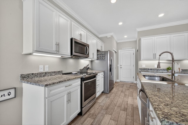 8343 Cinch Way, Lake Worth, FL 33467 - kitchen featuring stainless steel appliances, light wood-type flooring, white cabinetry, ornamental molding, and stone counters