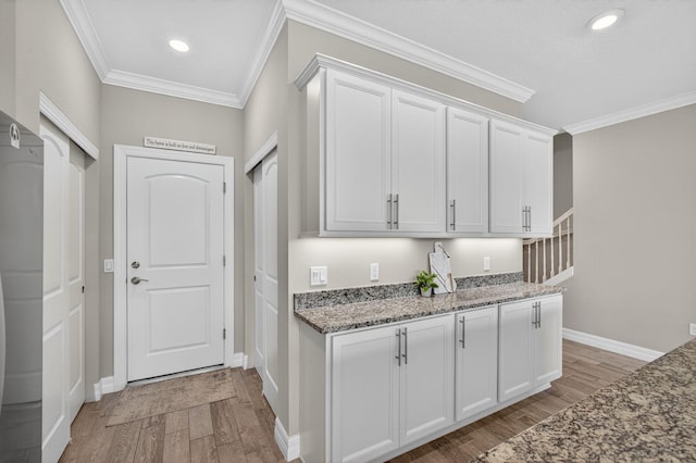 8343 Cinch Way, Lake Worth, FL 33467 - kitchen featuring light wood-type flooring, ornamental molding, white cabinetry, stone counters, and recessed lighting
