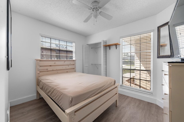 9890 W Heather Ln, Miramar, FL 33025 - bedroom featuring light wood finished floors, a textured ceiling, and ceiling fan