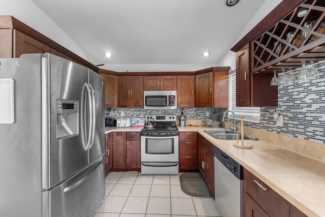 9890 W Heather Ln, Miramar, FL 33025 - kitchen with stainless steel appliances, decorative backsplash, light countertops, lofted ceiling, and light tile patterned floors