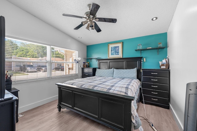 9890 W Heather Ln, Miramar, FL 33025 - bedroom with lofted ceiling, a textured ceiling, light wood-style flooring, and a ceiling fan
