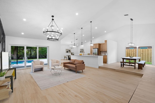 21436 Woodchuck Ln, Boca Raton, FL 33428 - living room featuring a chandelier, high vaulted ceiling, recessed lighting, and light wood-type flooring