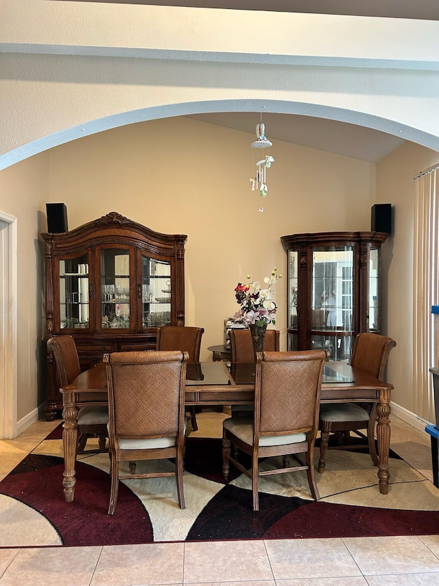 1701 SW Penrose Ave, Port Saint Lucie, FL 34953 - dining room featuring arched walkways, vaulted ceiling, and light tile patterned flooring
