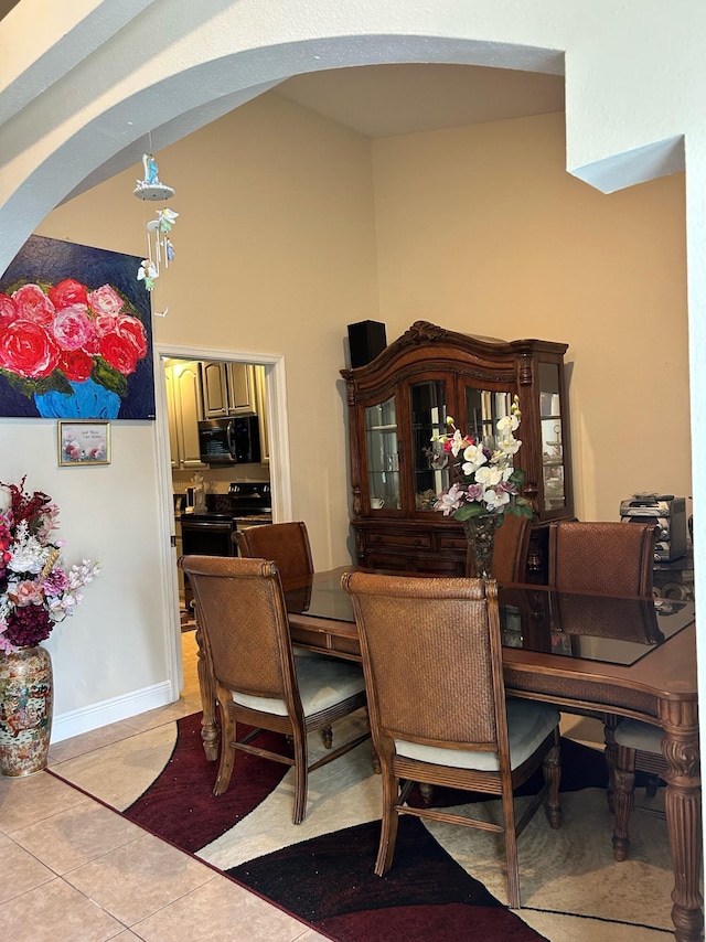 1701 SW Penrose Ave, Port Saint Lucie, FL 34953 - dining room with arched walkways, light tile patterned floors, and a high ceiling