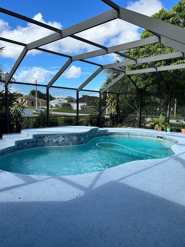 1701 SW Penrose Ave, Port Saint Lucie, FL 34953 - swimming pool with glass enclosure and a patio area