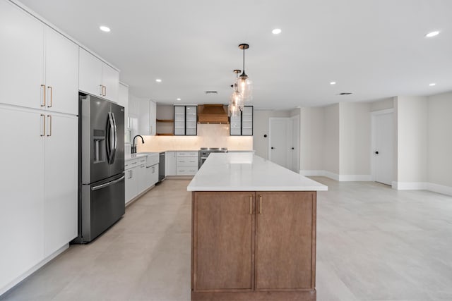 77 Fairview E, Tequesta, FL 33469 - kitchen with appliances with stainless steel finishes, premium range hood, a kitchen island, recessed lighting, and hanging light fixtures