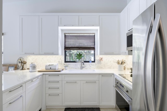 1085 Raintree Dr, Palm Beach Gardens, FL 33410 - kitchen with appliances with stainless steel finishes, tasteful backsplash, and white cabinetry