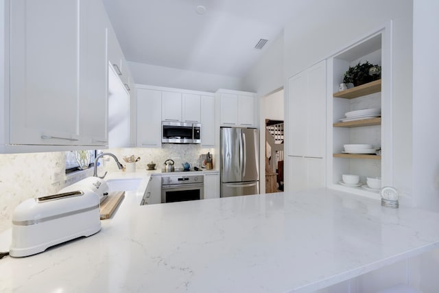 1085 Raintree Dr, Palm Beach Gardens, FL 33410 - kitchen with appliances with stainless steel finishes, open shelves, decorative backsplash, light stone counters, and a peninsula