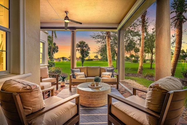 171 Tresana Blvd Unit 129, Jupiter, FL 33478 - patio terrace at dusk featuring outdoor lounge area, ceiling fan, a patio, and a yard