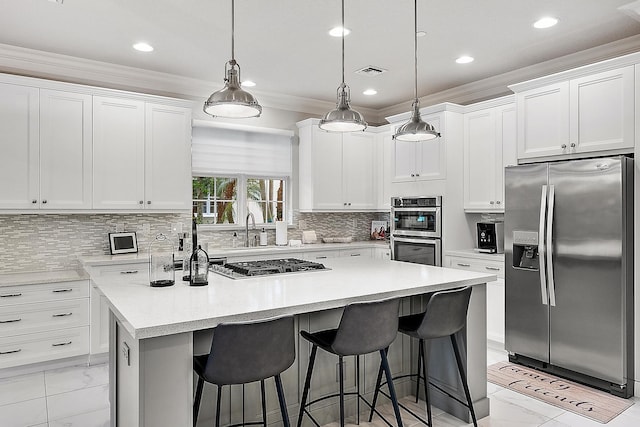 171 Tresana Blvd Unit 129, Jupiter, FL 33478 - kitchen with stainless steel appliances, light marble finish flooring, a center island, white cabinets, and recessed lighting