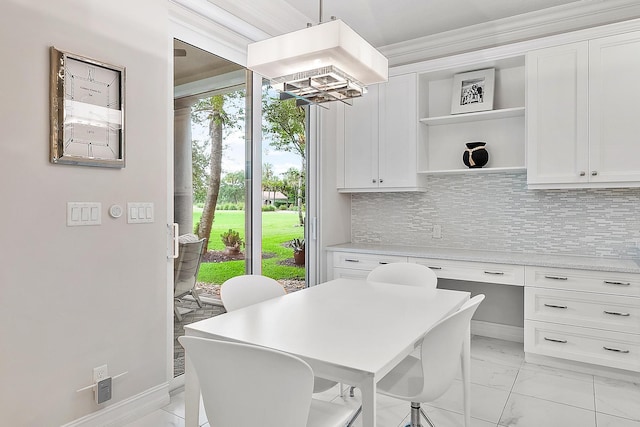 171 Tresana Blvd Unit 129, Jupiter, FL 33478 - dining space with light marble finish floors, a chandelier, and ornamental molding