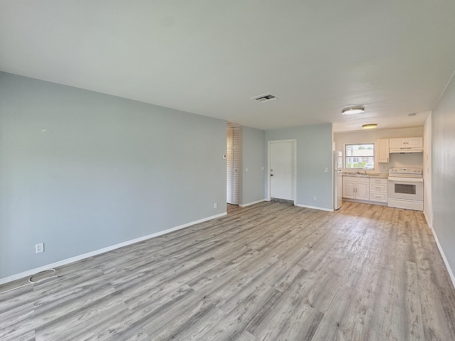 2885 Crosley Dr E Unit F, West Palm Beach, FL 33415 - unfurnished living room with light wood-type flooring and baseboards