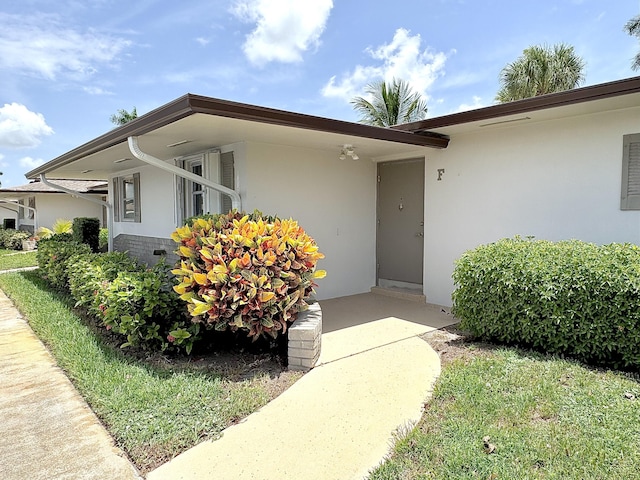 2885 Crosley Dr E Unit F, West Palm Beach, FL 33415 - doorway to property featuring stucco siding