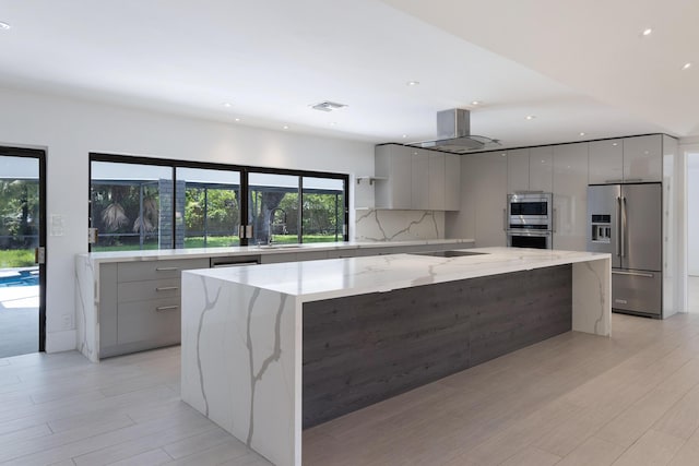 6532 Serena Ln, Boca Raton, FL 33433 - kitchen with modern cabinets, stainless steel appliances, a spacious island, gray cabinetry, and light wood-type flooring