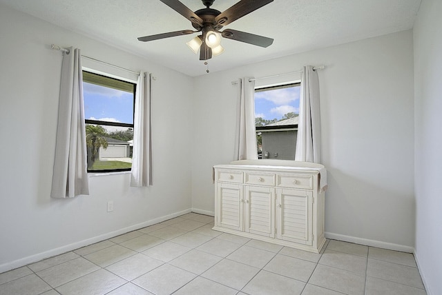 3126 SW Curcuma St, Port Saint Lucie, FL 34953 - empty room with a ceiling fan and light tile patterned floors