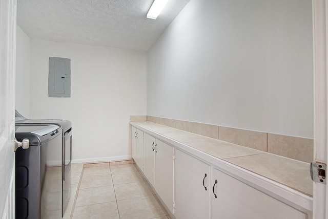 3126 SW Curcuma St, Port Saint Lucie, FL 34953 - laundry room featuring electric panel, cabinet space, washer and dryer, a textured ceiling, and light tile patterned floors