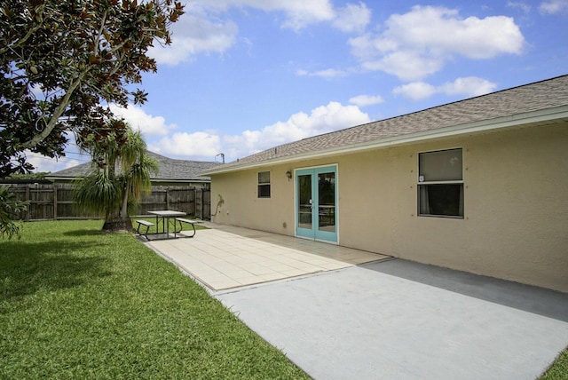 3126 SW Curcuma St, Port Saint Lucie, FL 34953 - rear view of house with stucco siding, a shingled roof, and a patio