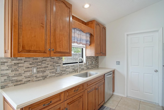 3126 SW Curcuma St, Port Saint Lucie, FL 34953 - kitchen featuring stainless steel dishwasher, tasteful backsplash, light tile patterned flooring, brown cabinetry, and a textured ceiling