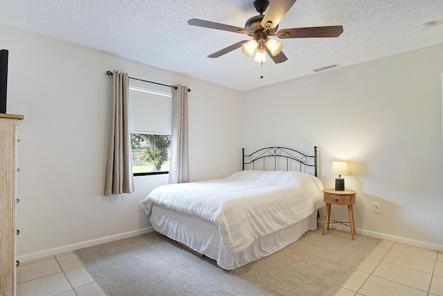 3126 SW Curcuma St, Port Saint Lucie, FL 34953 - bedroom with light tile patterned flooring, a textured ceiling, and ceiling fan