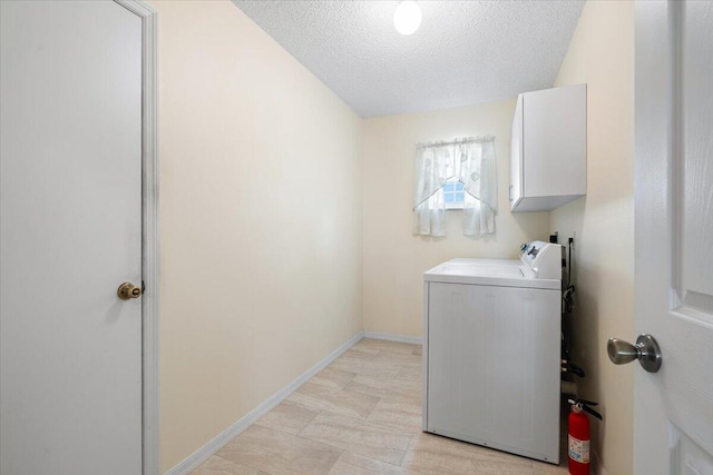 516 SW Crawfish Dr, Port Saint Lucie, FL 34953 - washroom with cabinet space, separate washer and dryer, and a textured ceiling