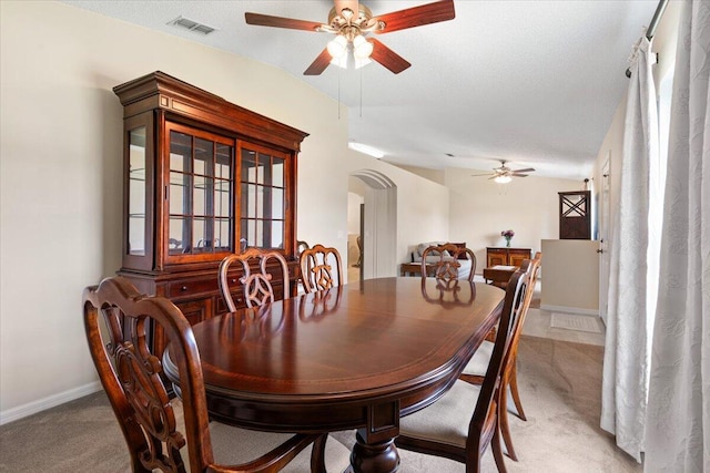 516 SW Crawfish Dr, Port Saint Lucie, FL 34953 - dining area with light carpet, a ceiling fan, and arched walkways