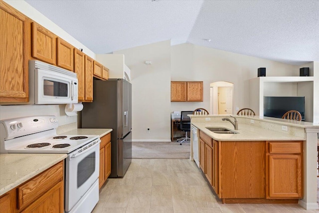 516 SW Crawfish Dr, Port Saint Lucie, FL 34953 - kitchen featuring white appliances, lofted ceiling, a kitchen island with sink, light stone counters, and brown cabinets