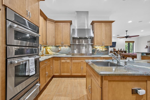 11085 86th St N, Palm Beach Gardens, FL 33412 - kitchen with stainless steel double oven, wall chimney exhaust hood, a warming drawer, light stone counters, and decorative backsplash