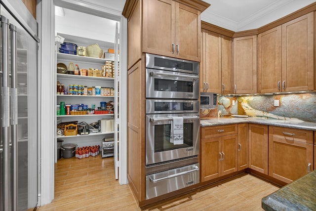 11085 86th St N, Palm Beach Gardens, FL 33412 - kitchen featuring a warming drawer, stainless steel appliances, light stone countertops, backsplash, and crown molding
