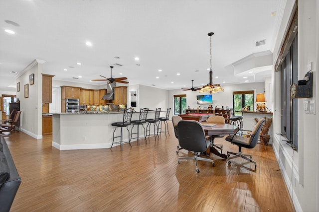 11085 86th St N, Palm Beach Gardens, FL 33412 - dining space featuring ceiling fan, crown molding, recessed lighting, light wood-type flooring, and a chandelier