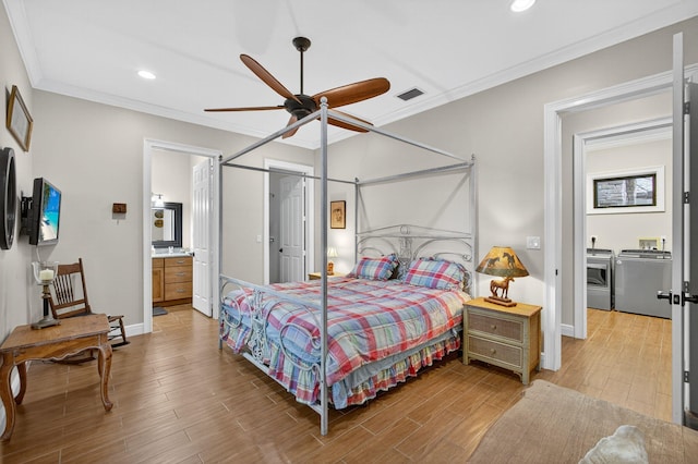 11085 86th St N, Palm Beach Gardens, FL 33412 - bedroom featuring washer and dryer, light wood-style flooring, ornamental molding, recessed lighting, and ensuite bath