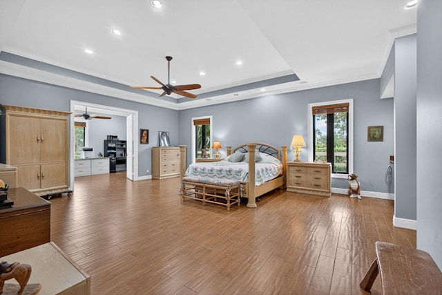 11085 86th St N, Palm Beach Gardens, FL 33412 - bedroom featuring a tray ceiling, multiple windows, wood finished floors, ornamental molding, and recessed lighting