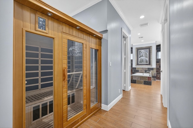11085 86th St N, Palm Beach Gardens, FL 33412 - corridor with a sauna, ornamental molding, and light wood-type flooring