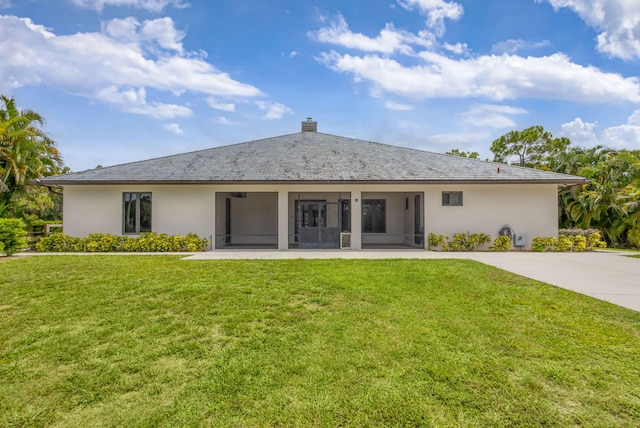 11085 86th St N, Palm Beach Gardens, FL 33412 - rear view of property with a lawn, a sunroom, and stucco siding
