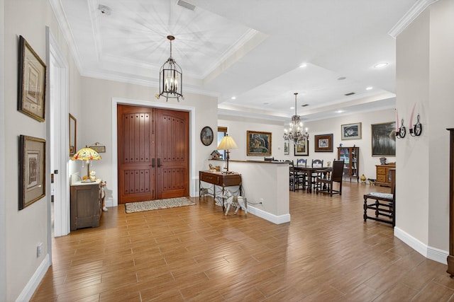 11085 86th St N, Palm Beach Gardens, FL 33412 - foyer entrance with a chandelier, a raised ceiling, light wood-type flooring, crown molding, and recessed lighting