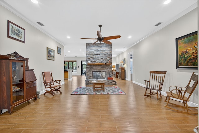11085 86th St N, Palm Beach Gardens, FL 33412 - living room featuring ornamental molding, a stone fireplace, recessed lighting, ceiling fan, and wood finished floors